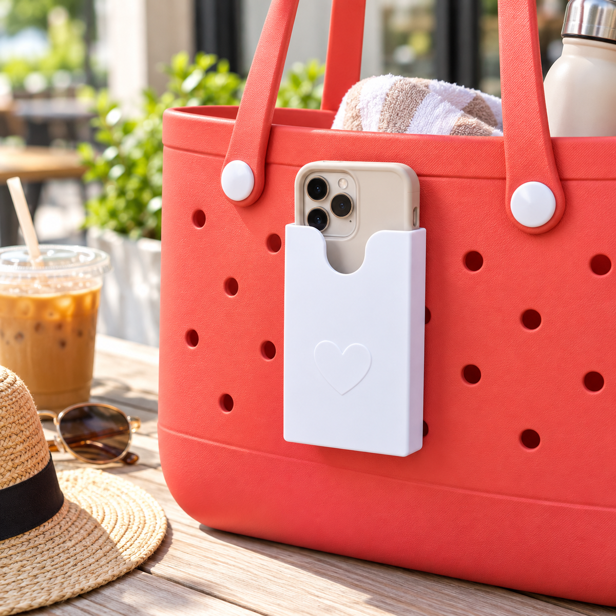 White phone holder mounted on coral perforated tote