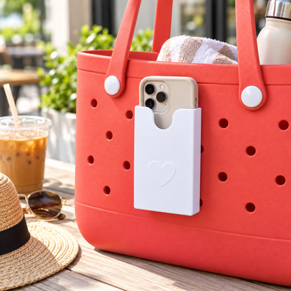 White phone holder mounted on coral perforated tote